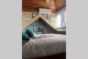 a bedroom with a bed in a house at Coconut Castle at La Lodge at Long Bay in Big Corn Island