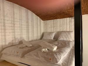 a white bed with two pillows on top of it at ApartmentSun Loft Factory in Wrocław