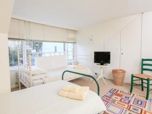 a room with two beds and a tv at 2 North Crest House in Salcombe