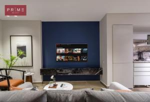 a living room with a couch and a blue wall at Prime Select El Batal in Cairo