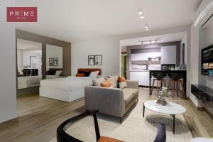 a bedroom and living room with a bed and a couch at Prime Select El Batal in Cairo