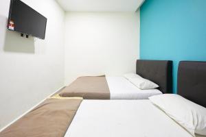 Postel nebo postele na pokoji v ubytování Hotel 3Winz, Chow Kit Hospital Kuala Lumpur