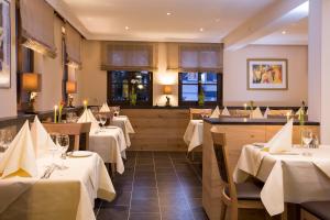 a restaurant with tables with white table cloth at Hotel Rössle in Alpirsbach