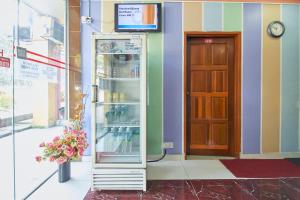 a refrigerator in front of a building with a door at Hotel 3WINZ in Kuala Lumpur