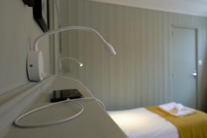 a hospital room with a bed and a phone at Vert Lodge Chamonix in Chamonix-Mont-Blanc