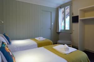 a hotel room with two beds and a window at Vert Lodge Chamonix in Chamonix-Mont-Blanc