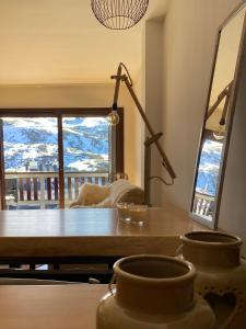 a dining room with a table and a large window at Ático con vistas increibles a pie de pista y garaje incluido in Sierra Nevada