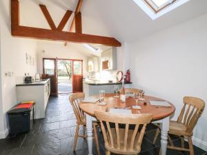 a kitchen and dining room with a wooden table and chairs at Dovecote Field House Farm in Newark-on-Trent