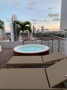 a hot tub on the roof of a building at GOLD FLAT MANAÍRA 1705 in João Pessoa