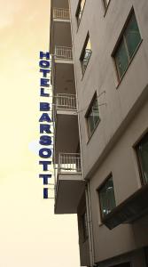 a building with a sign on the side of it at Hotel Barsotti in Brindisi