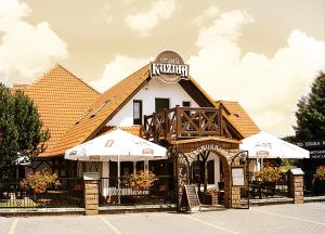 a building with a sign on top of it at Stara Kuźnia Mazurska in Węgorzewo