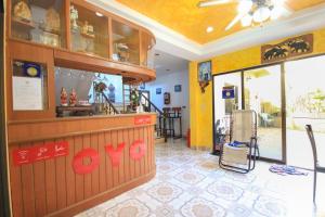 a restaurant with a counter in a room at Ban Elephant Blanc Apartment in Kata Beach