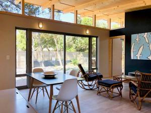 a dining room with a table and chairs at Palm and Pine Cottage in Cape Town