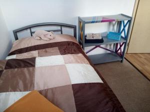 a bedroom with a bed with a stuffed animal on it at Ferienwohnung in Rathenow Süd in Rathenow
