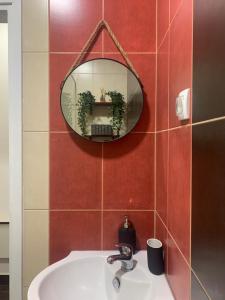 a bathroom with a sink and a mirror on a wall at Old Town City Center in Belgrade