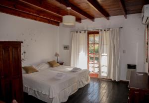 a bedroom with a bed and a large window at Nuevas Cabañas Del Sol in San Lorenzo