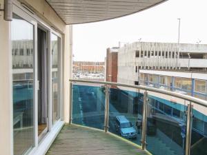 a balcony with a view of a car in a parking lot at Nautical Breeze in Weymouth