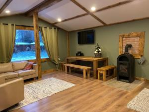 a living room with a couch and a wood stove at Camping Bušas in Saulkrasti