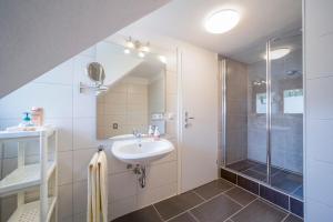 a bathroom with a shower and a sink at Gästehaus Sandvoss in Titisee-Neustadt +89 photos