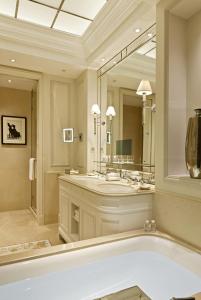 
a bathroom with a tub, sink and mirror at Beau-Rivage Palace in Lausanne
