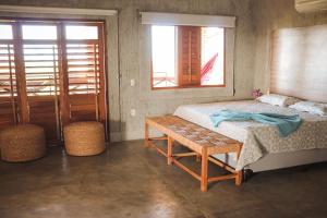 a bedroom with a bed and a table and two windows at Orla Piaui in Luis Correia +41 photos