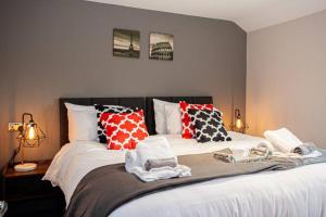 a bedroom with a large bed with pillows on it at Fabulous Newly Refurbished Apartment - Great Links in Bury