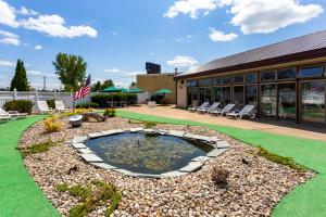 a patio with a pond in front of a building at Quality Inn & Suites Plattsburgh in Plattsburgh