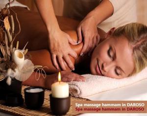 a woman receiving a massage in a spa massage hamacist in dhoya at Hammam Spa Villa DAROSO in Kosiv