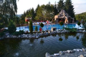 a large swimming pool in a resort with a water park at Club Vila Bran in Bran