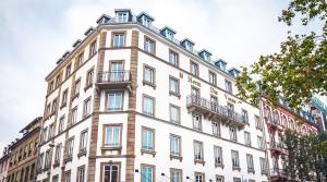 a tall white building with balconies on it at Hotel des Vosges BW Premier Collection in Strasbourg