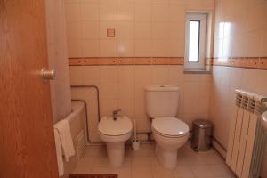 a bathroom with a toilet and a sink at Casa das Tias in Manteigas +10 photos