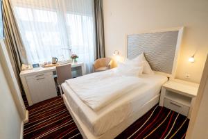 Een bed of bedden in een kamer bij Yors Hotel Hannover City