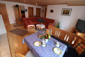 a living room with a table and a couch at Haus Blumenfeld-Schwaiger in Übersee