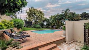 a backyard with a swimming pool and a fence at Home Away From Home Pinetown in Pinetown