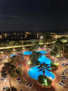 an overhead view of a resort pool at night at Nissiana Hotel & Bungalows in Ayia Napa