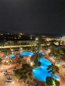 an aerial view of a resort pool at night at Nissiana Hotel & Bungalows in Ayia Napa