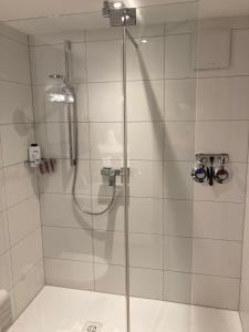 a shower with a glass door in a bathroom at Ferienwohnung Familie Zuck in Missen-Wilhams