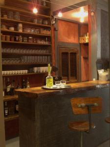 a bar with a bottle of wine and a stool at Chambres d'hôtes L'Epicurium in Le Puy en Velay