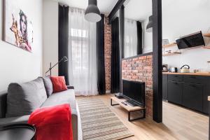 Televízia a/alebo spoločenská miestnosť v ubytovaní MARGI Igram Apartament