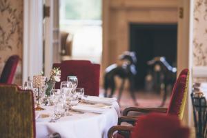 a table with plates and wine glasses on it at Rowton Castle in Shrewsbury