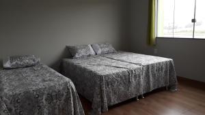 Llit o llits en una habitació de Pousada Pérola Mineira