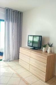 a television sitting on top of a dresser in a room at MNG-Apart Aloha Garden Costa Adeje in Adeje +23 photos