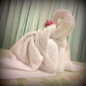 a white towel with a flower on top of it at Casa Copalchi in Monteverde Costa Rica