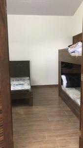 a room with two bunk beds and a tile floor at Casa Mar e Montanha 2, deck com vista para o mar in Trindade