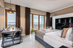 sypialnia z dużym łóżkiem i stołem z biurkiem w obiekcie Ambria Apartments Platan Tower w Świnoujściu