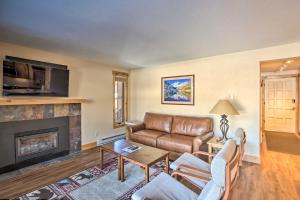 a living room with a couch and a fireplace at Ski-In Breck Condo Walk to Shops and Restaurants! in Breckenridge