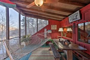 un portico con amaca, tavolo e panca di Spacious Waterfront Retreat with Dock and Hot Tub a Mentone