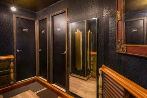 a dressing room with black walls and wooden floors at The Clock Hostel & Suites in Cartagena de Indias