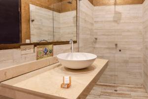 a bathroom with a white bowl sink on a counter at The Clock Hostel & Suites in Cartagena de Indias