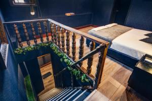 a staircase leading to a room with a bed and a bed sqor at The Clock Hostel & Suites in Cartagena de Indias